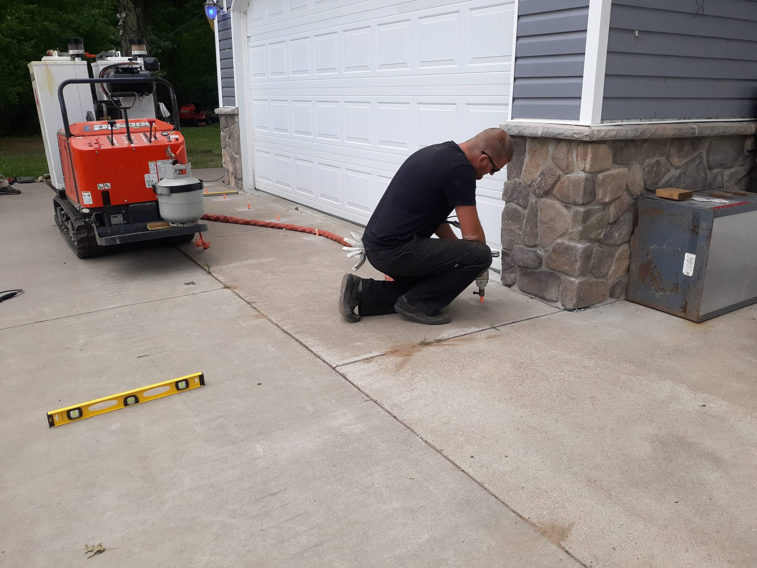 Polyurethane foam injection lifting settled concrete slab on Iowa farm or commercial property