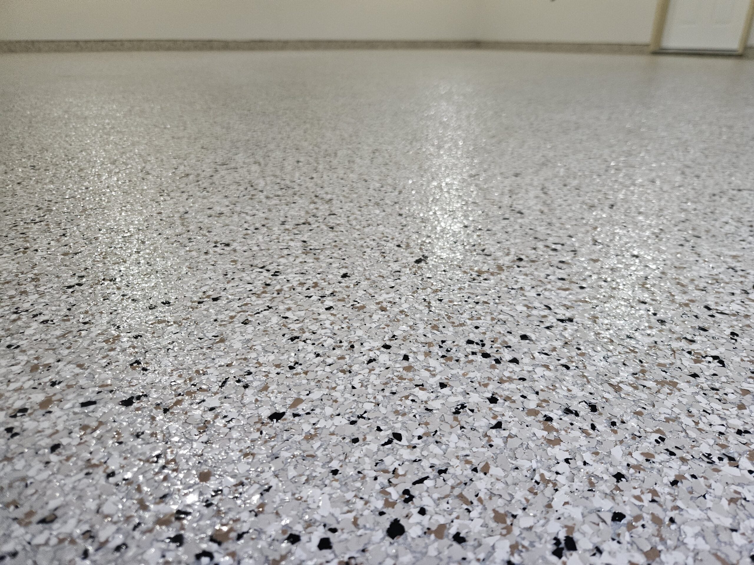 Close-up of color flake epoxy floor showing texture detail and high gloss finish