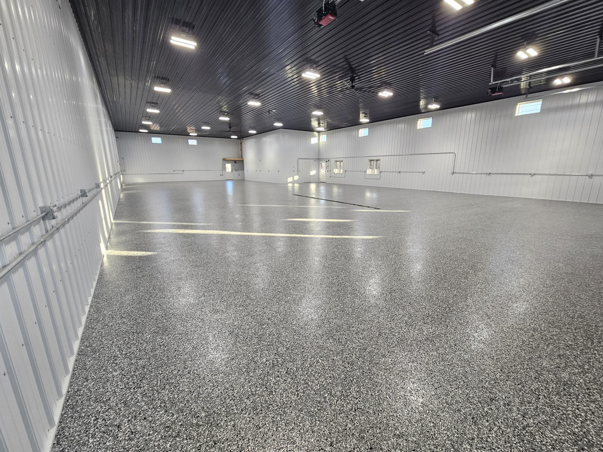 Commercial epoxy floor coating installed in large metal building – Upper Midwest concrete floor coatings by TCS