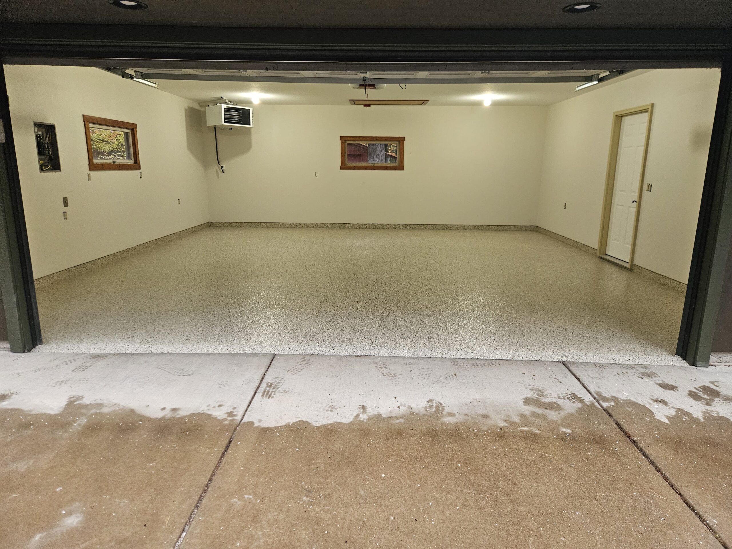 Completed epoxy floor coating in Iowa garage or commercial shop facility