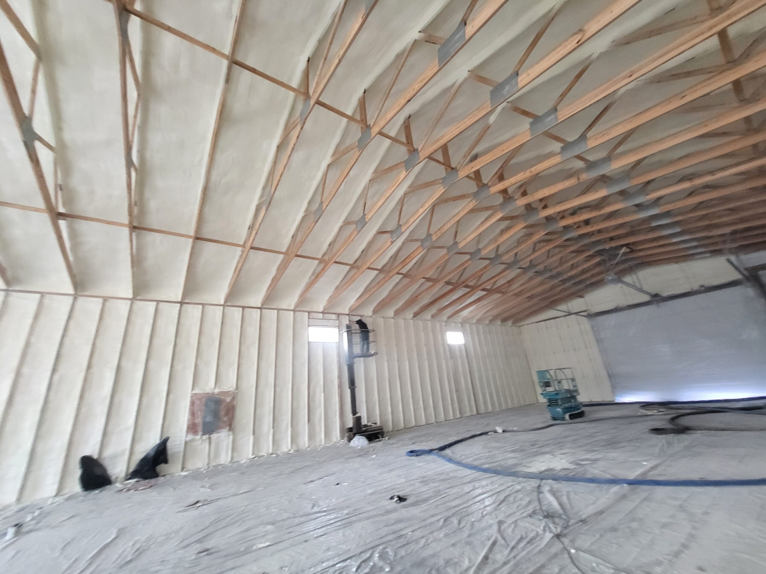 Closed-cell spray foam insulation applied in Iowa agricultural building interior metal framing