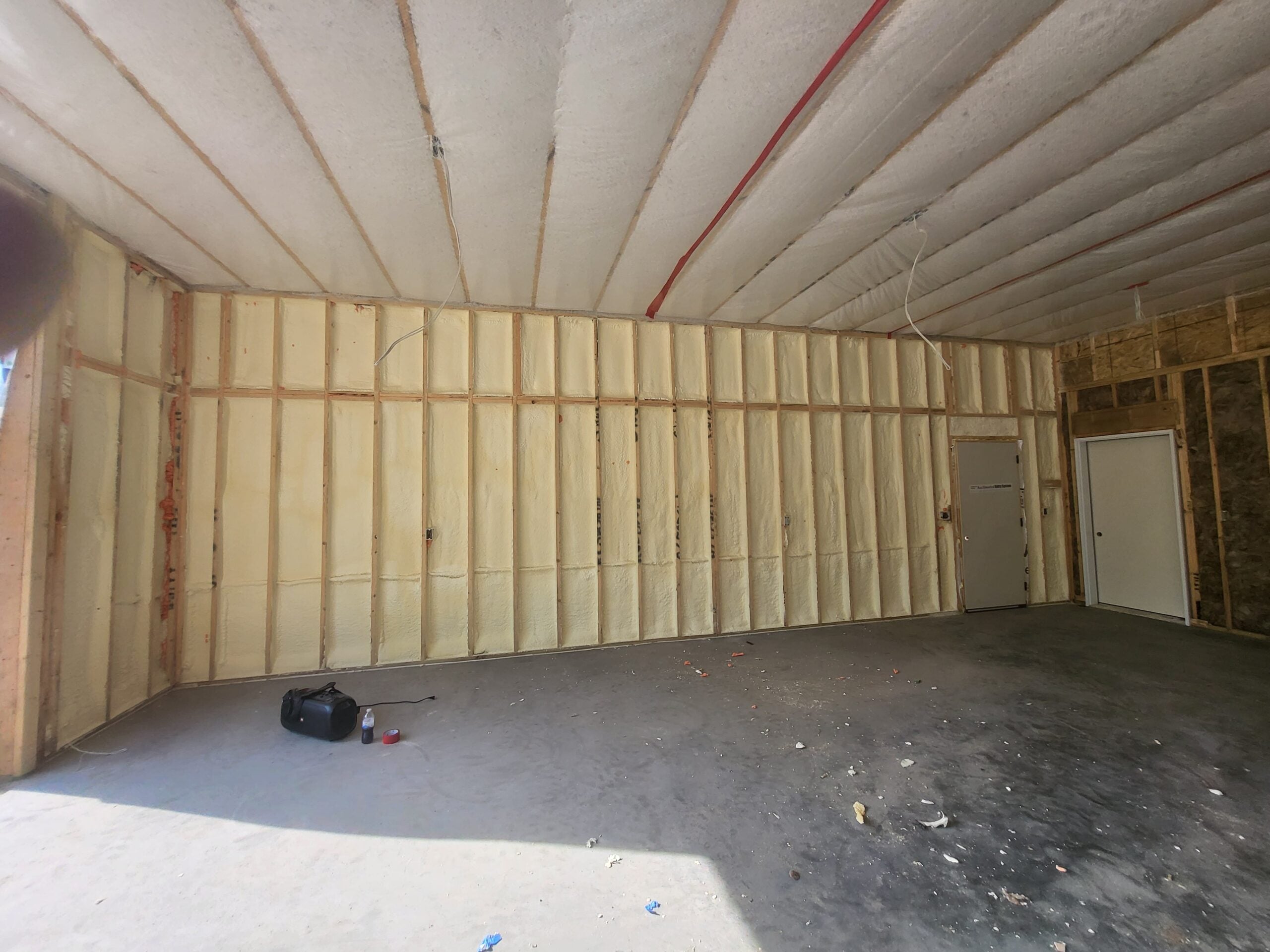 New pole barn yellow spray foam on all walls and ceiling pre-drywall stage in Fargo
