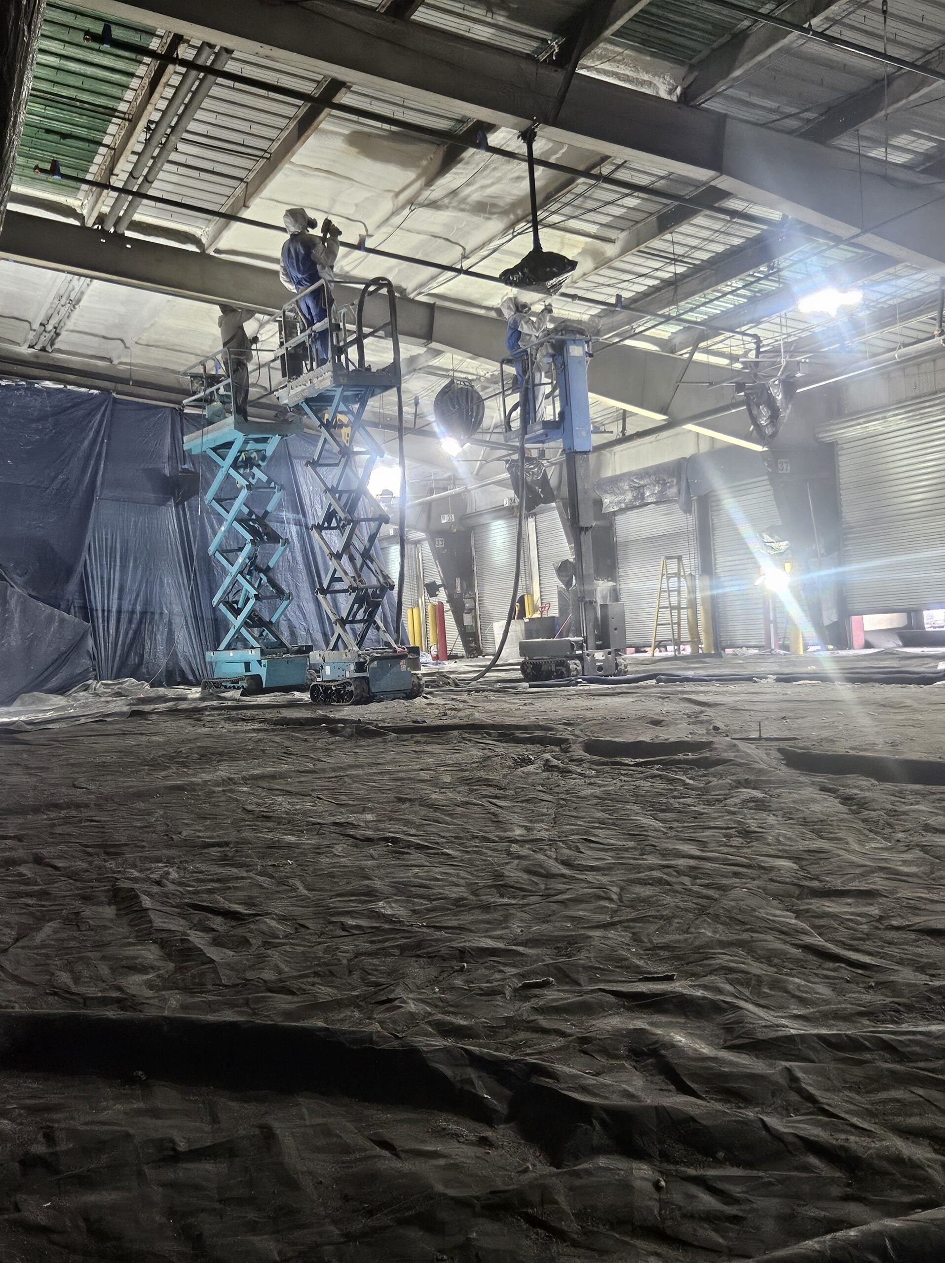 Commercial spray foam insulation contractor serving Upper Midwest – TCS crew applying foam in large warehouse facility