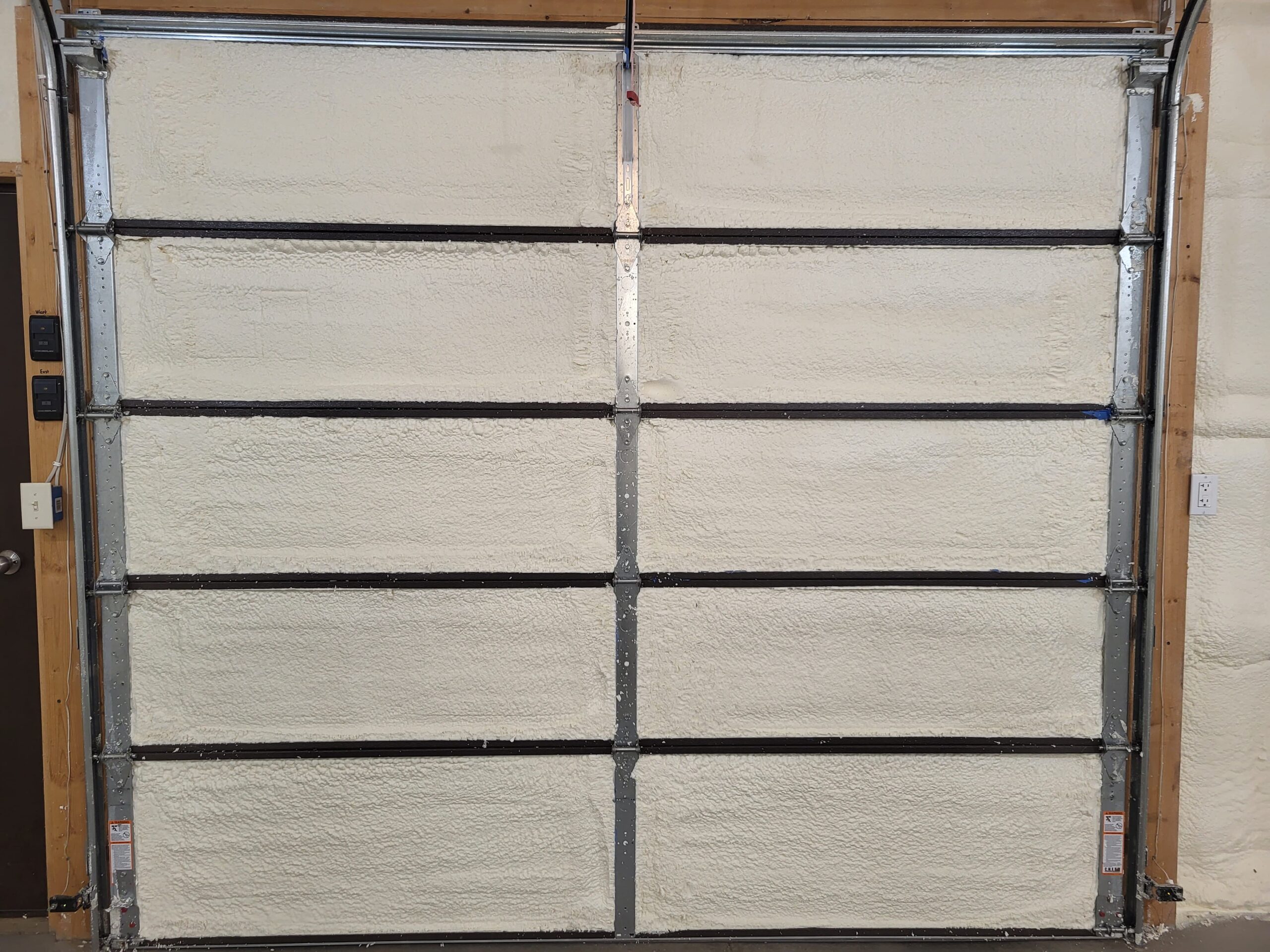 Spray foam applied to crawl space and garage panels in Bismarck ND